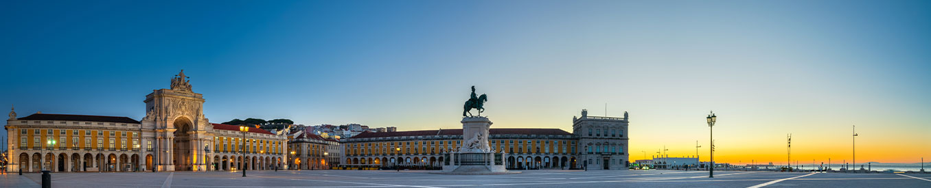 Empty Commerce Square in Lisbon, Portugal at sunrise with the statue of José 1 mounted on his horse Gentil